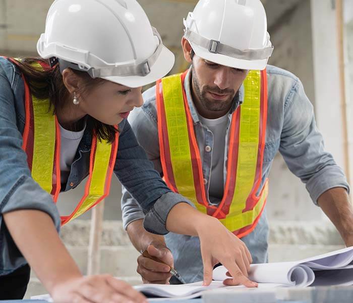 Working of engineer at building site talking and discussing on document . Teamwork site inspector and discuss together